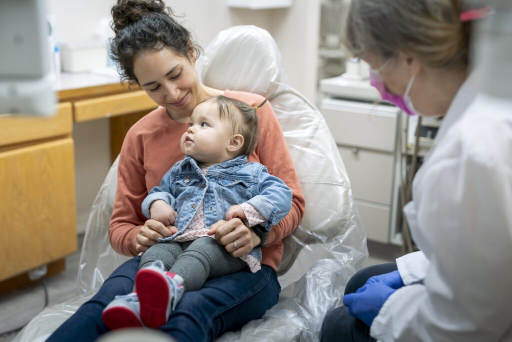 The American Academy of Pediatric Dentistry (AAPD) recommends a dental visit by the time their first tooth erupts.